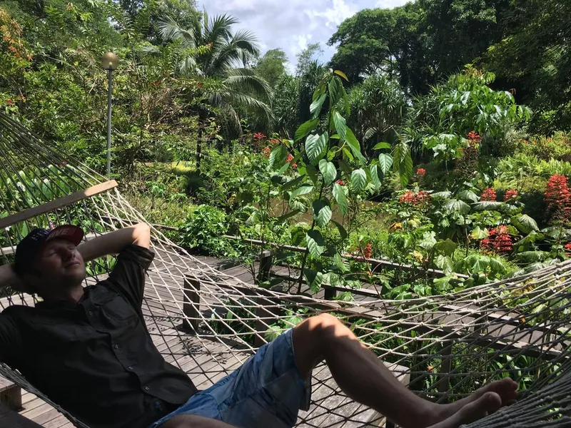 Tim in a hammock at the edge of the Borneo rainforest